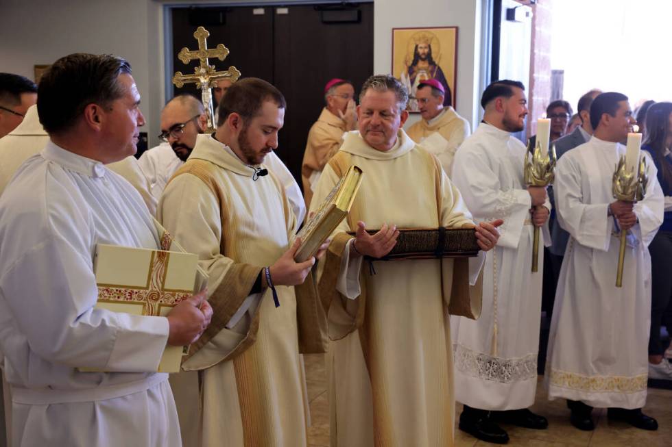 Members of the clergy prepare for the imposition of the Pallium Mass at the Shrine of the Most ...