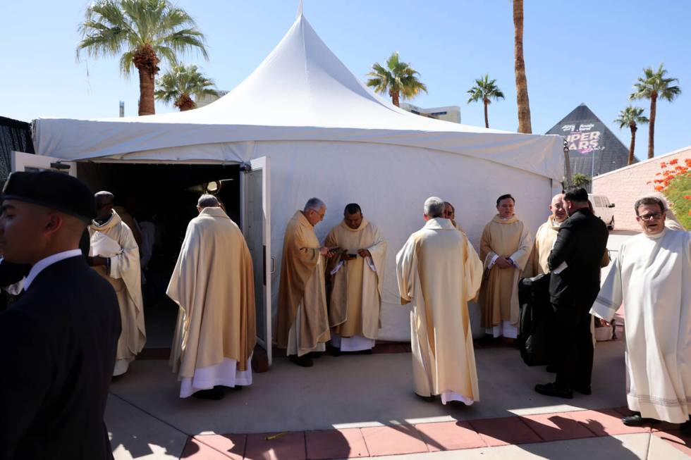 Members of the clergy prepare for the imposition of the Pallium Mass at the Shrine of the Most ...