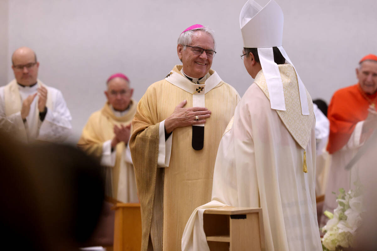 Archbishop George Leo Thomas, left, receives the Pallium from Apostolic Nuncio to the United St ...