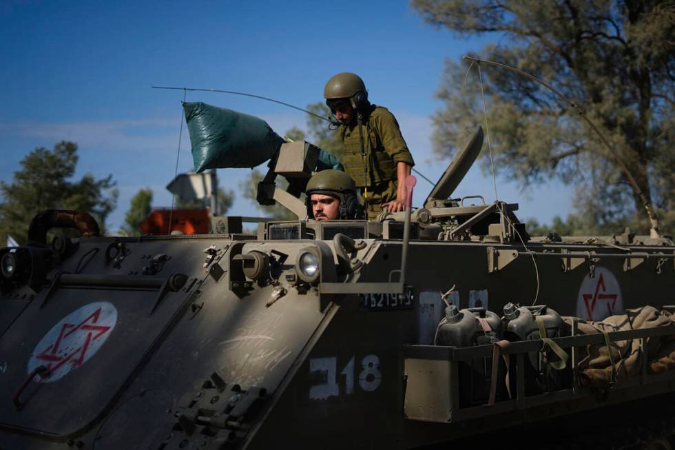 Israeli soldiers gather in a staging area near the border with Gaza Strip, in southern Israel T ...