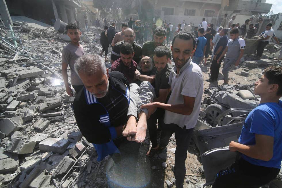 Palestinians evacuate wounded in the Israeli bombardment of Rafah, southern Gaza Strip, Tuesday ...