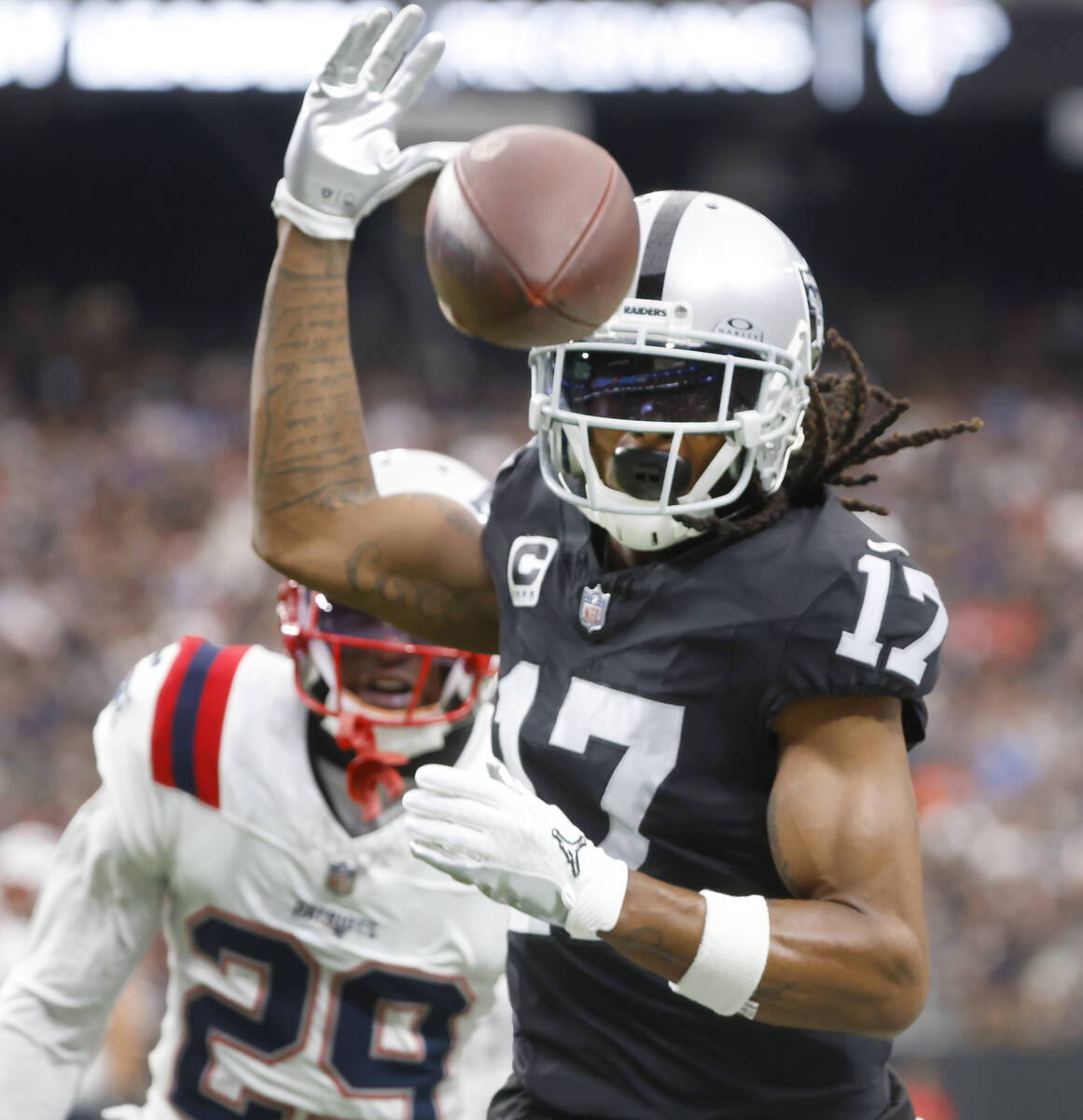 Raiders wide receiver Davante Adams (17) misses the ball as New England Patriots cornerback J.C ...