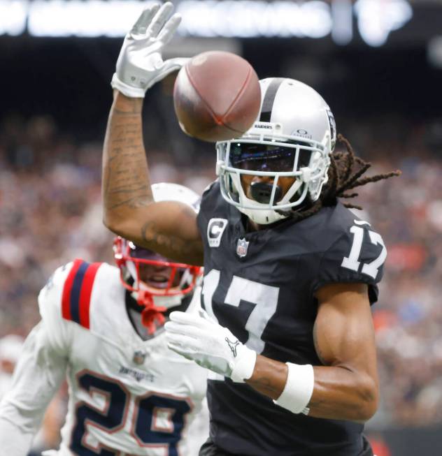 Raiders wide receiver Davante Adams (17) misses the ball as New England Patriots cornerback J.C ...