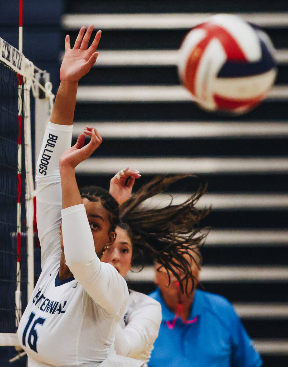 Centennial middle blocker Jada Thomas-Swinson (16) watches the ball as it moves past her during ...