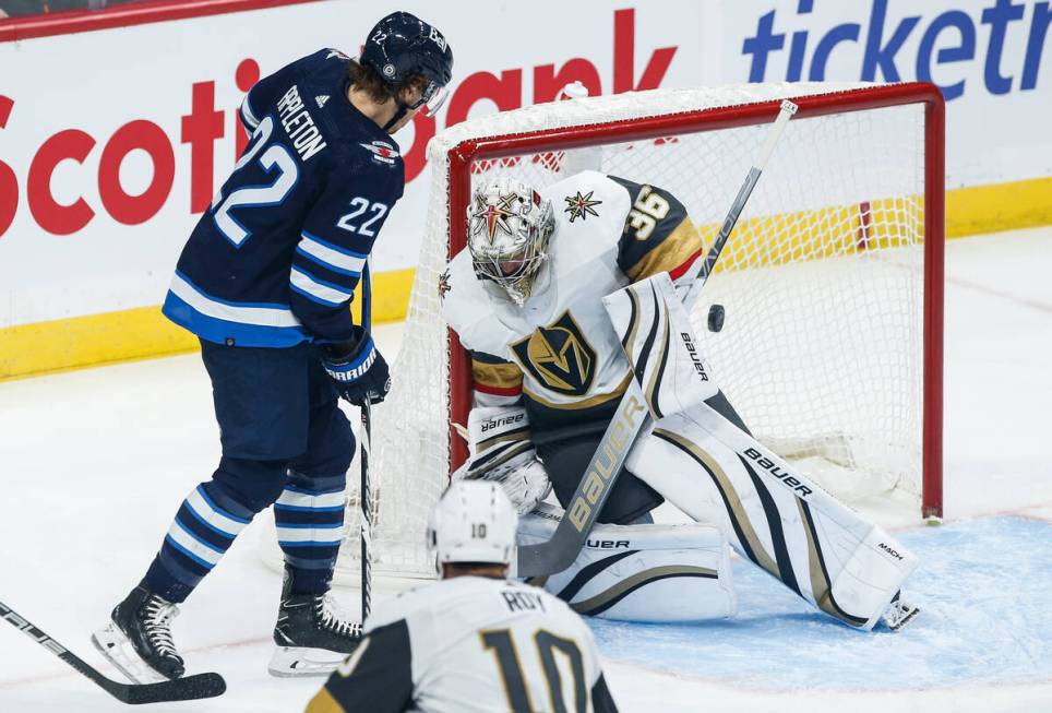 Vegas Golden Knights goaltender Logan Thompson (36) saves the deflection from Winnipeg Jets' Ma ...