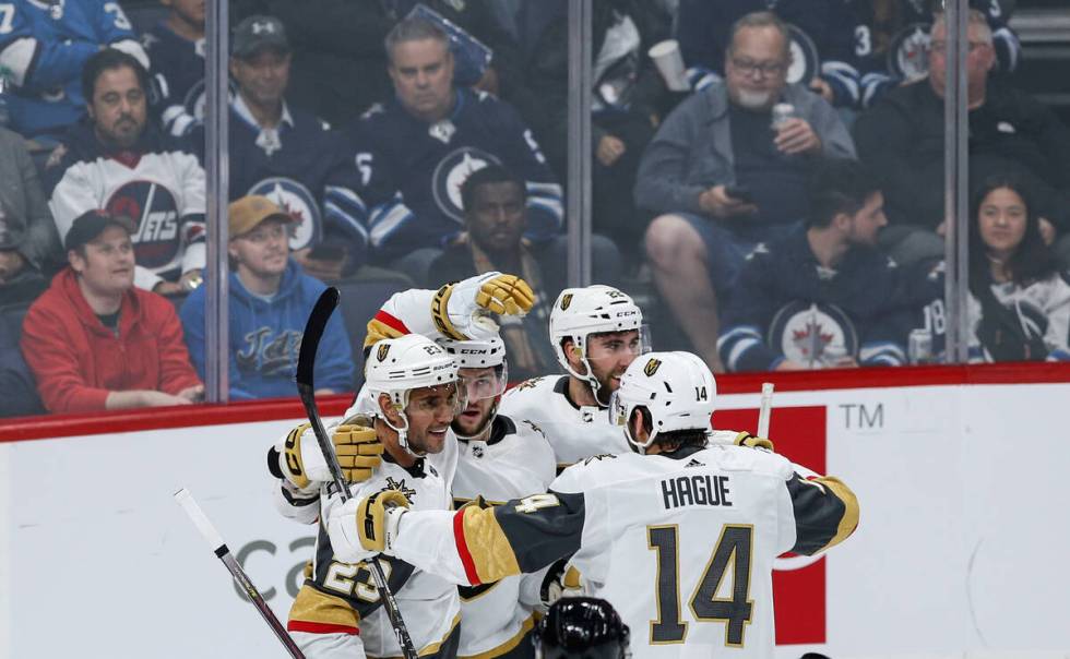 Vegas Golden Knights' Alec Martinez (23), Paul Cotter (43), Michael Amadio (22) and Nicolas Hag ...