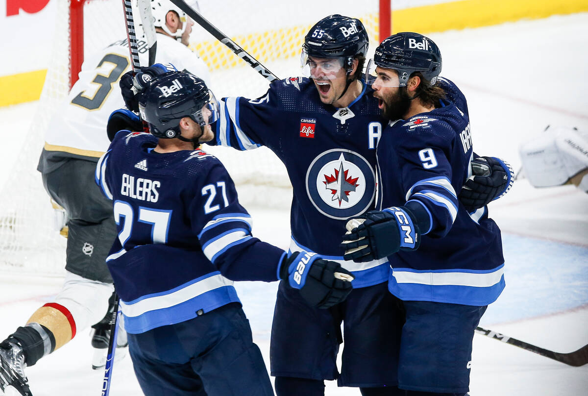 Winnipeg Jets' Nikolaj Ehlers (27), Mark Scheifele (55) and Alex Iafallo (9) celebrate after Ia ...