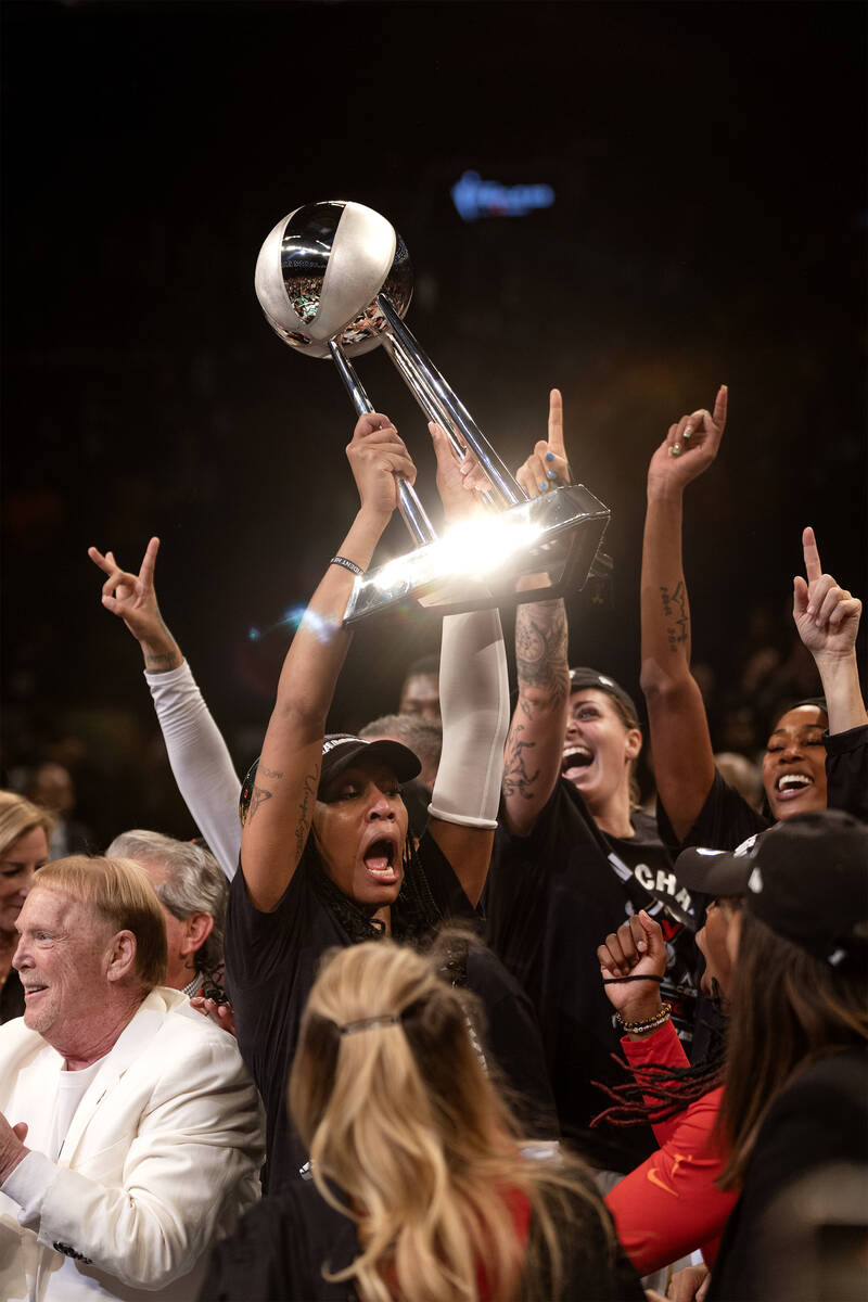 Las Vegas Aces forward A'ja Wilson (22) holds up her team’s championship trophy after wi ...