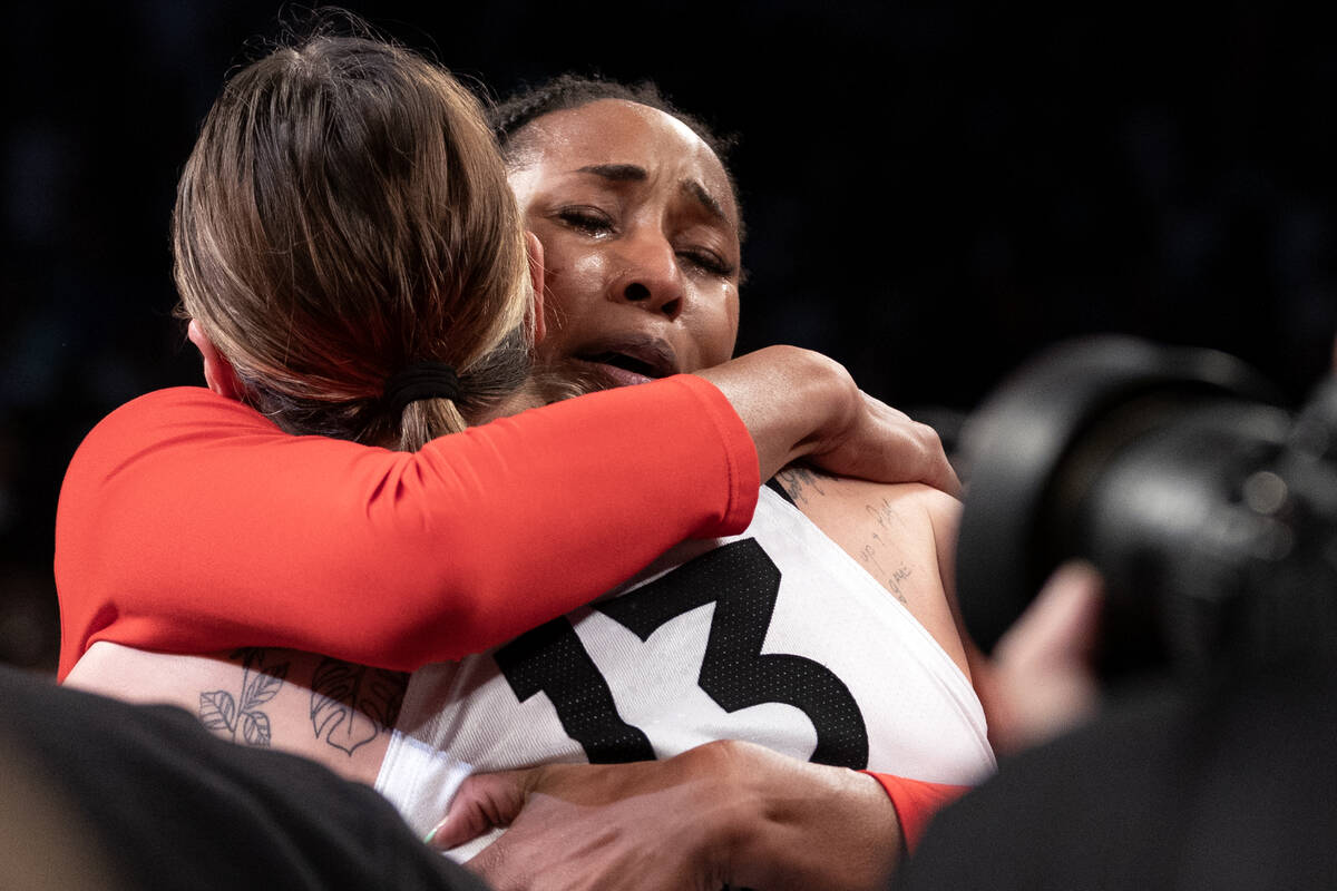 Las Vegas Aces center Alaina Coates, right, and forward Cayla George embrace after winning Game ...