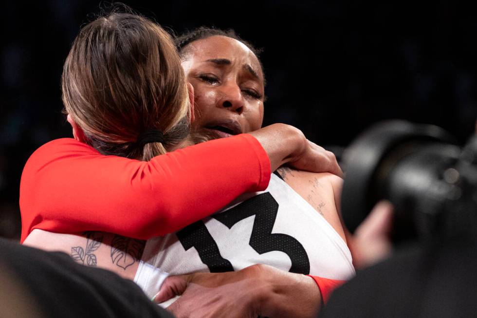 Las Vegas Aces center Alaina Coates, right, and forward Cayla George embrace after winning Game ...