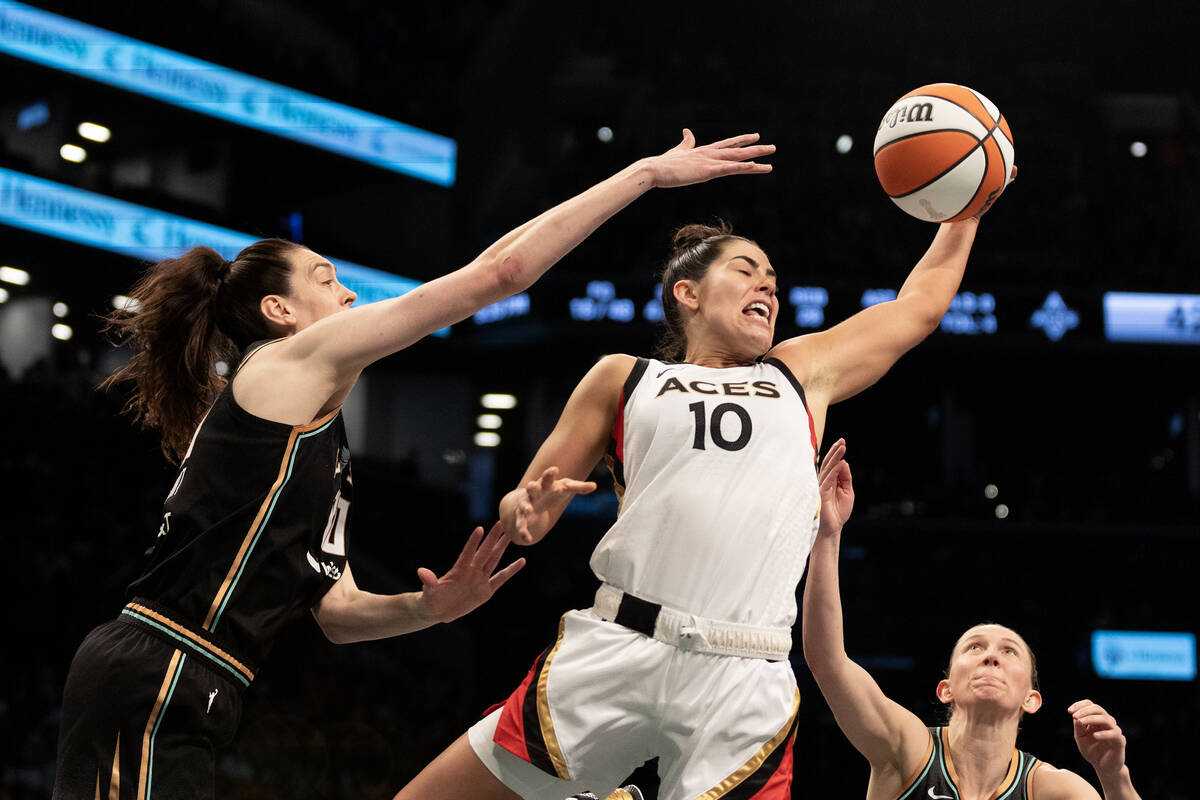 Las Vegas Aces guard Kelsey Plum (10) snags a rebound from New York Liberty forward Breanna Ste ...