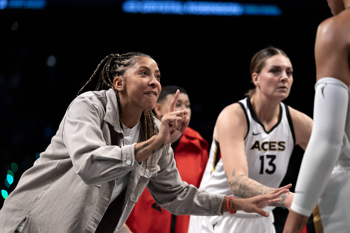Las Vegas Aces forward Candace Parker gestures to forward A'ja Wilson, out of frame at right, i ...
