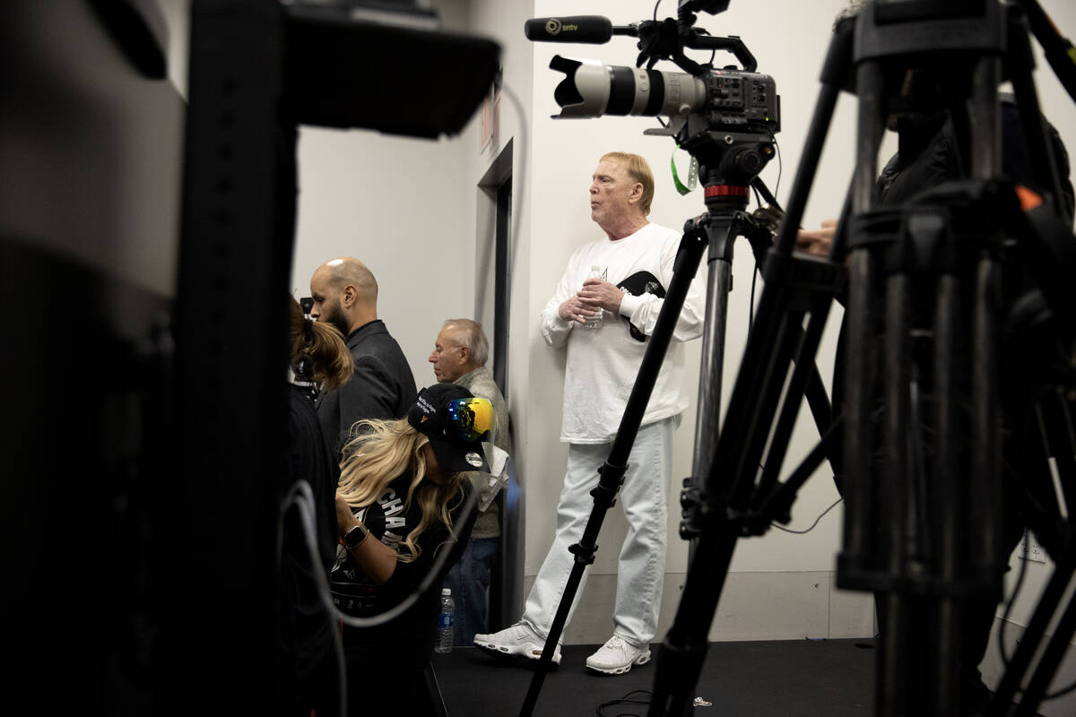 Las Vegas Aces owner Mark Davis hangs back with the television cameras to watch his team speak ...