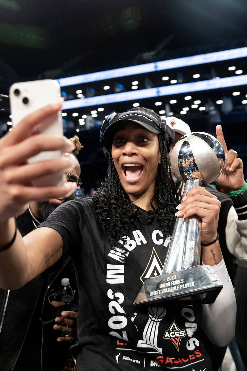 Las Vegas Aces forward A'ja Wilson poses for a selfie with her Most Valuable Player trophy afte ...