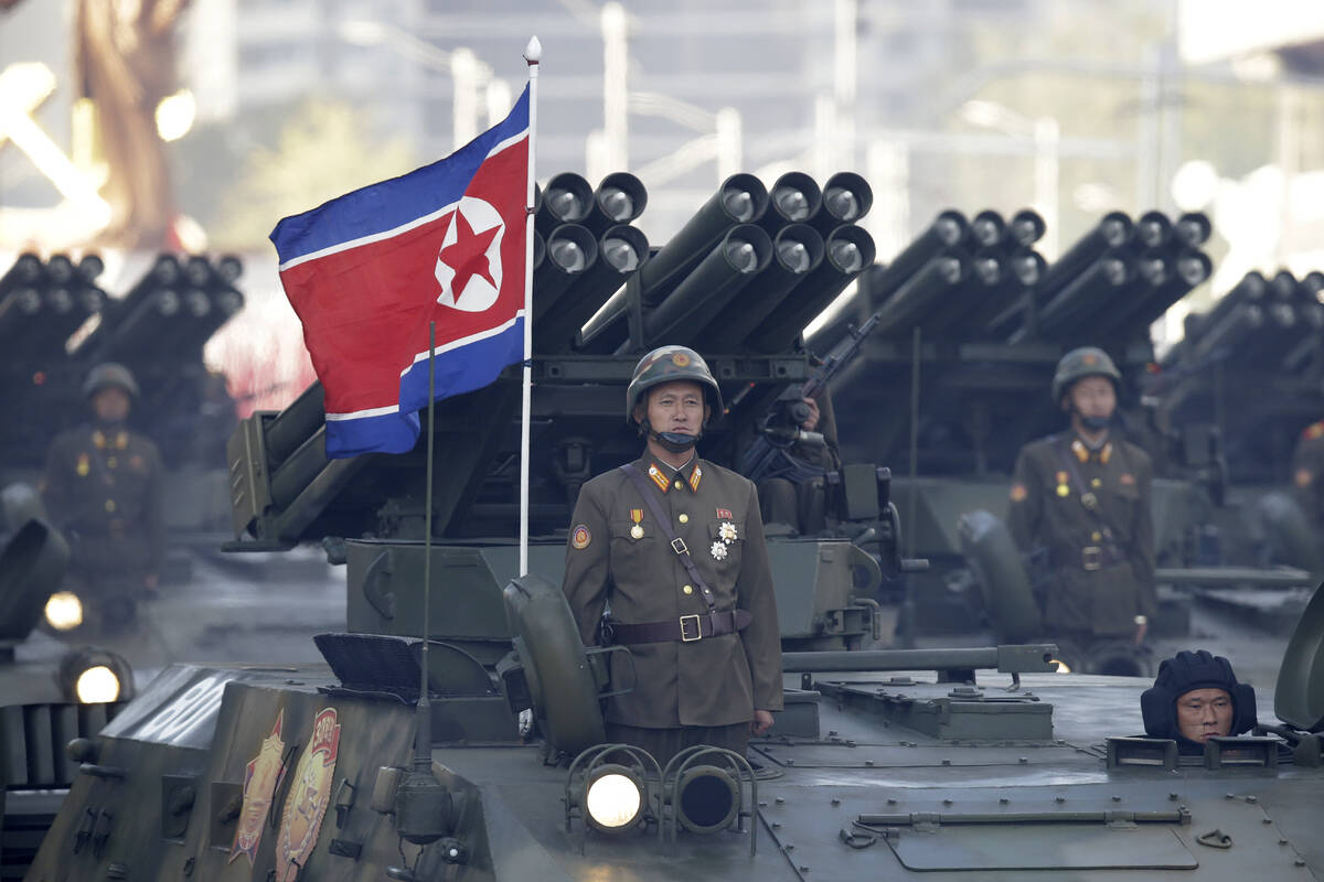 FILE - North Korean soldiers stand on armored vehicles with rocket launchers as they parade in ...