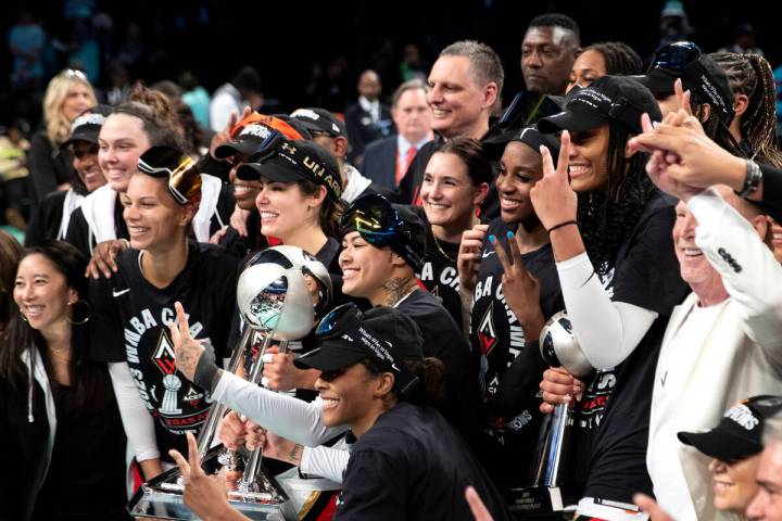 The Las Vegas Aces pose with their trophy after winning Game 4 of a WNBA basketball final serie ...