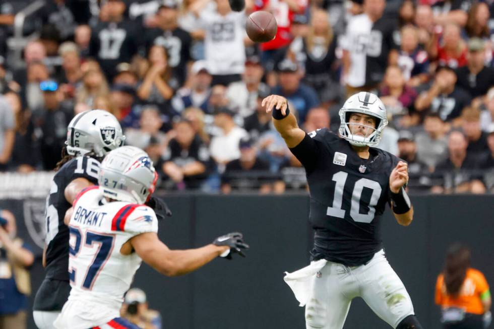 Raiders quarterback Jimmy Garoppolo (10) throws under pressure during an NFL football game agai ...