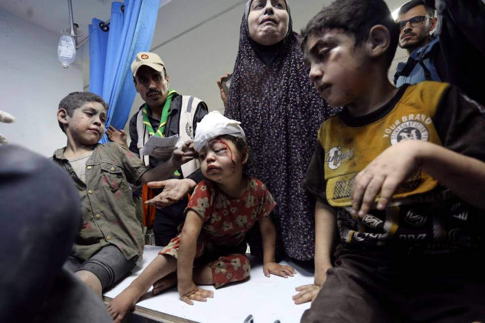 Wounded Palestinians arrive at the al-Shifa hospital following Israeli airstrikes on Gaza City, ...