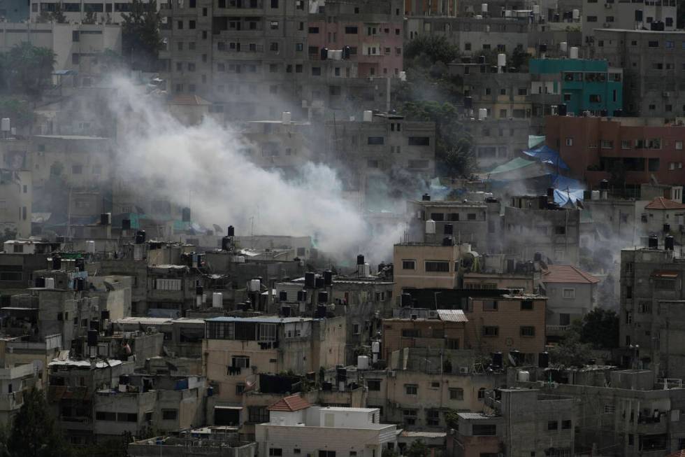 Smoke rises during an Israeli military raid on Nur Shams, West Bank, on Thursday, Oct. 19, 2023 ...