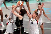 Las Vegas Aces forward Alysha Clark (7) and forward Cayla George (13) deny a shot by New York L ...