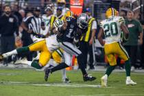 Raiders wide receiver Davante Adams (17) makes a catch as Green Bay Packers linebacker Isaiah M ...