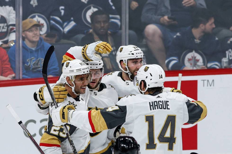 Vegas Golden Knights' Alec Martinez (23), Paul Cotter (43), Michael Amadio (22) and Nicolas Hag ...