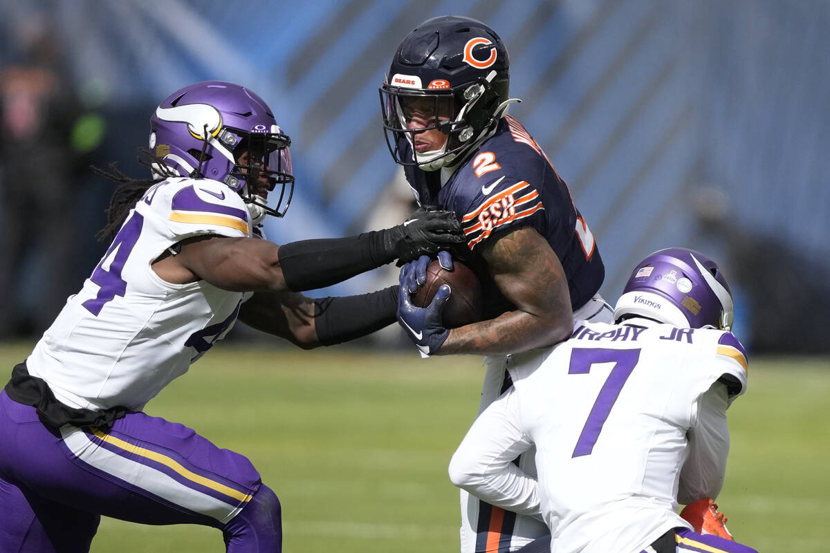 Chicago Bears wide receiver DJ Moore (2) catches a pass from quarterback Justin Fields as Minne ...