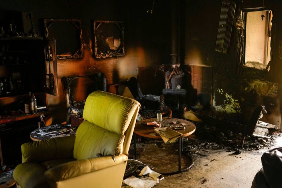 Destroyed furniture and charred walls are seen in a home that came under attack during a massiv ...