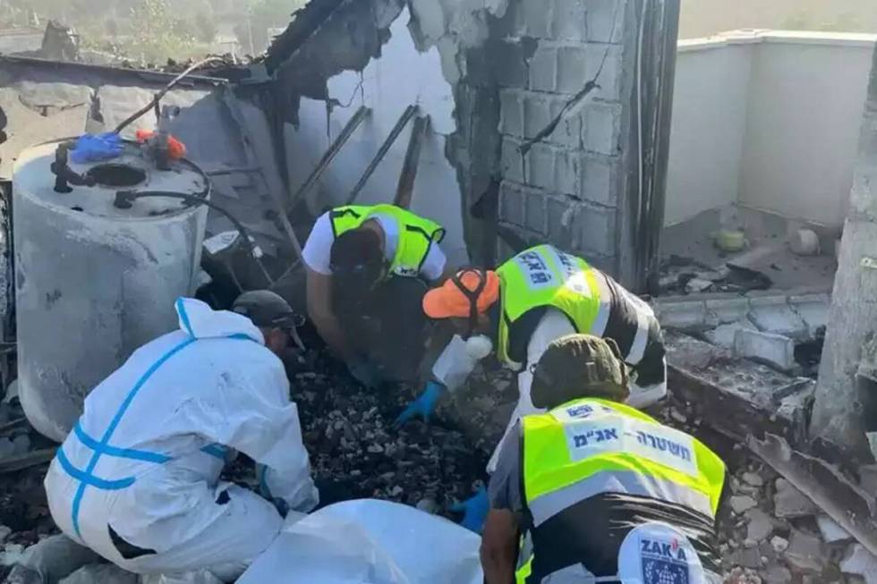 Volunteers of the ZAKA emergency response team working to locate the bodies of murdered Israeli ...