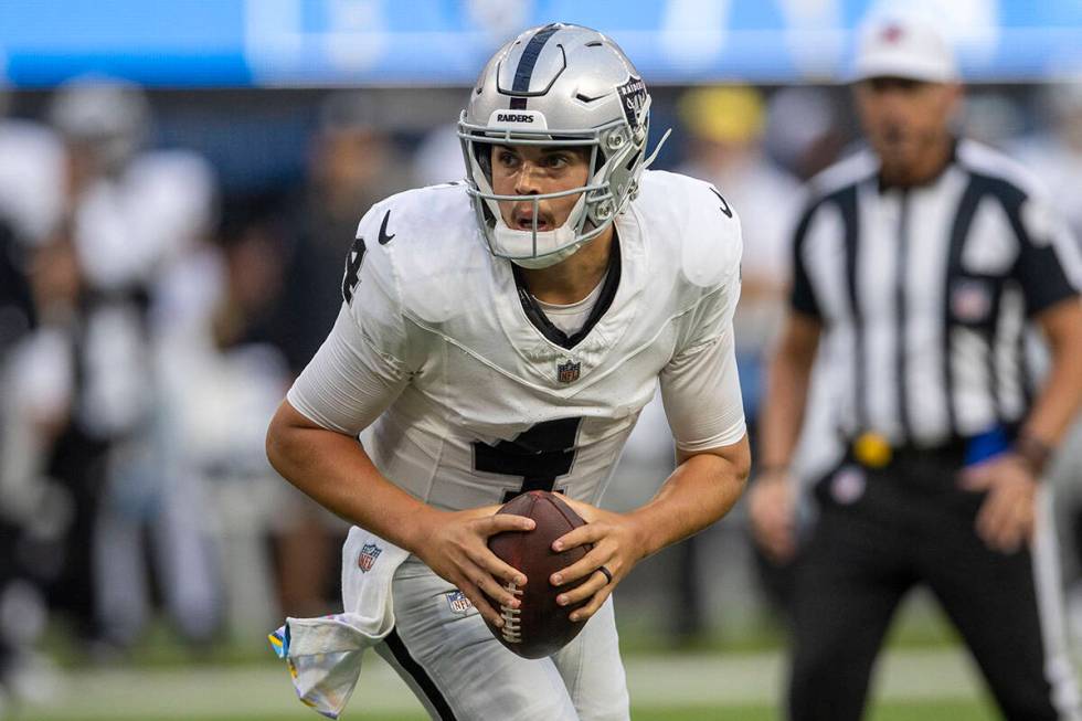 Raiders quarterback Aidan O'Connell (4) looks to throw during the second half an NFL game again ...