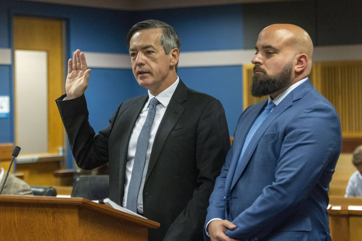 Attorney Scott Grubman, right, stands with his client, Kenneth Chesebro as Chesebro is sworn in ...