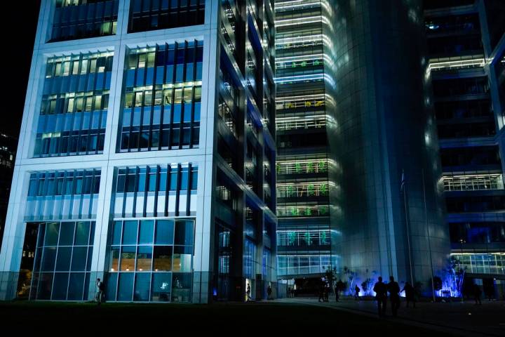 People walk outside a building on the Kirya compound, which houses Israel's Ministry of Defense ...