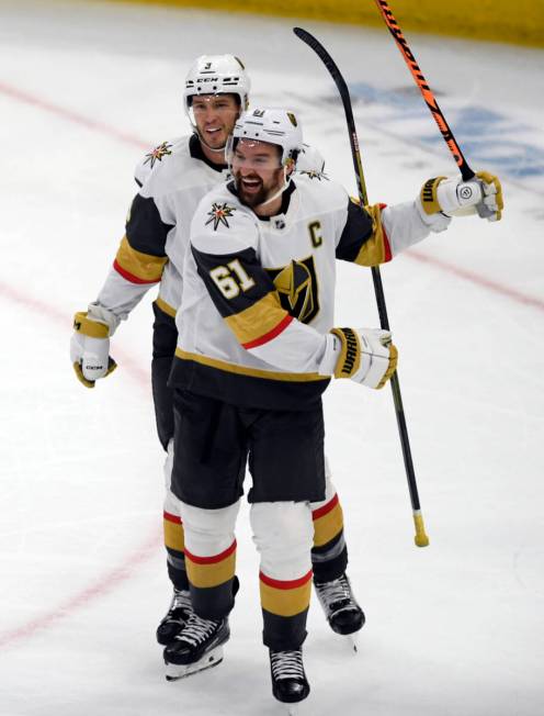 Vegas Golden Knights' Mark Stone (61) celebrates with teammate Brayden McNabb (3) after scoring ...