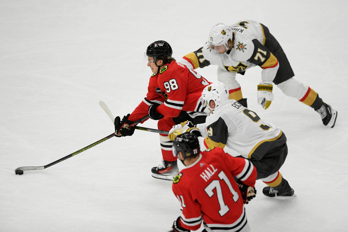 Chicago Blackhawks' Connor Bedard (98) moves the puck against Vegas Golden Knights' William Kar ...