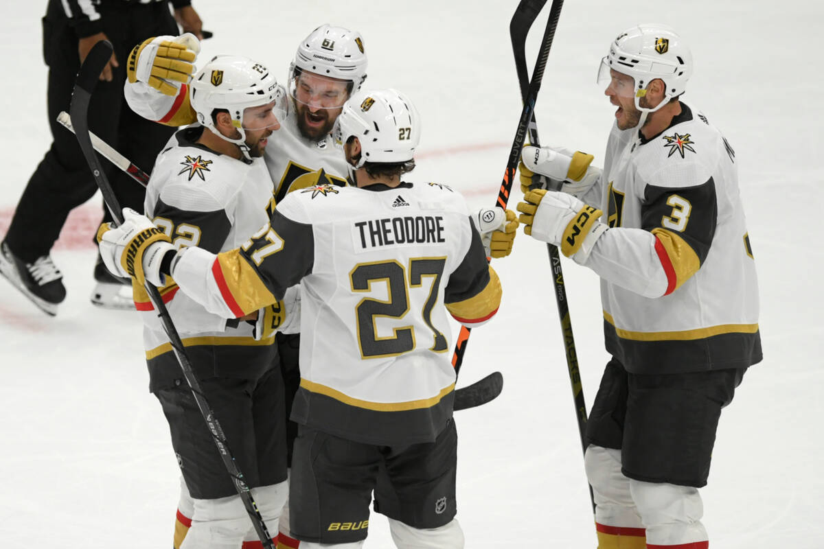 Vegas Golden Knights' Mark Stone (61) celebrates with teammates Brayden McNabb (3), Shea Theodo ...