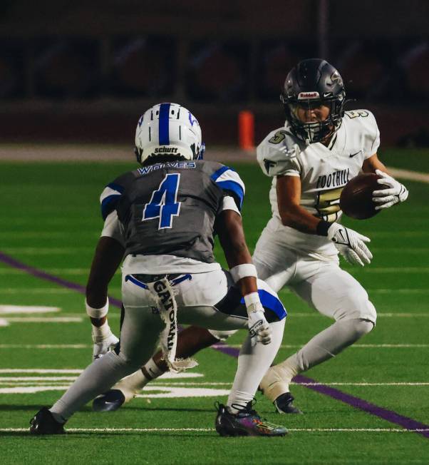 Basic cornerback Chris Smith (4) closes in on Foothill wide receiver Chase Kennedy (5) as he ca ...