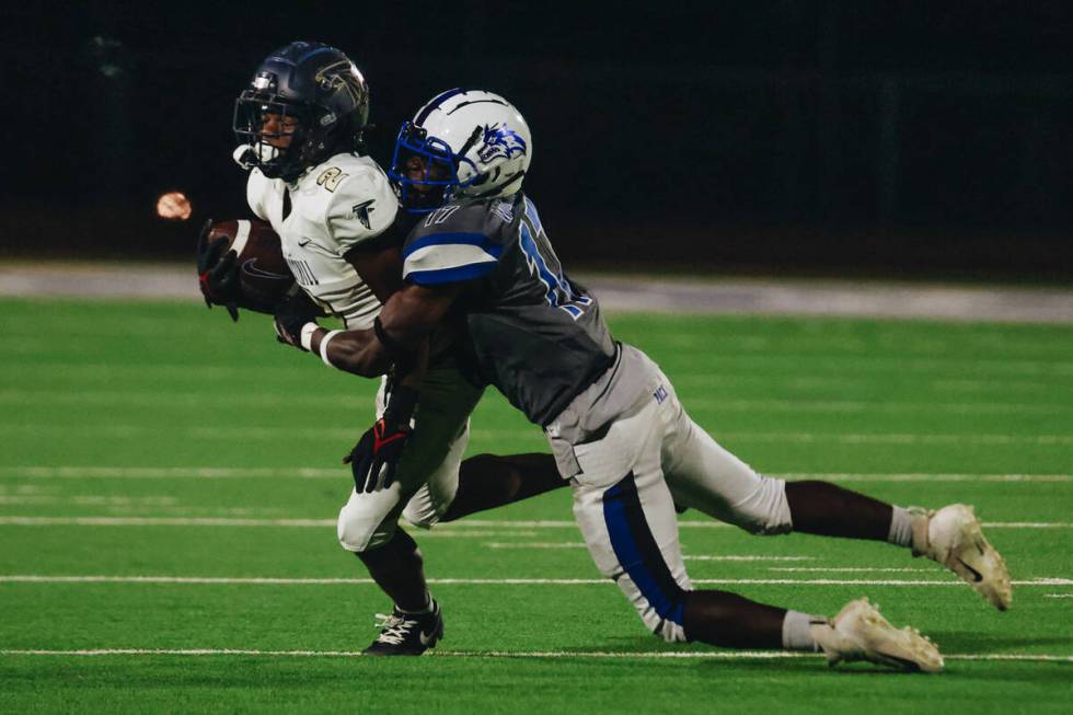 Foothill wide receiver Terrell Mack-Lovely muscles his way through the defense of Basic linebac ...