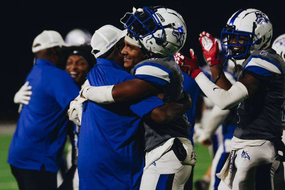 Basic players and coaching staff celebrate their win over Foothill following a game at Basic Ac ...