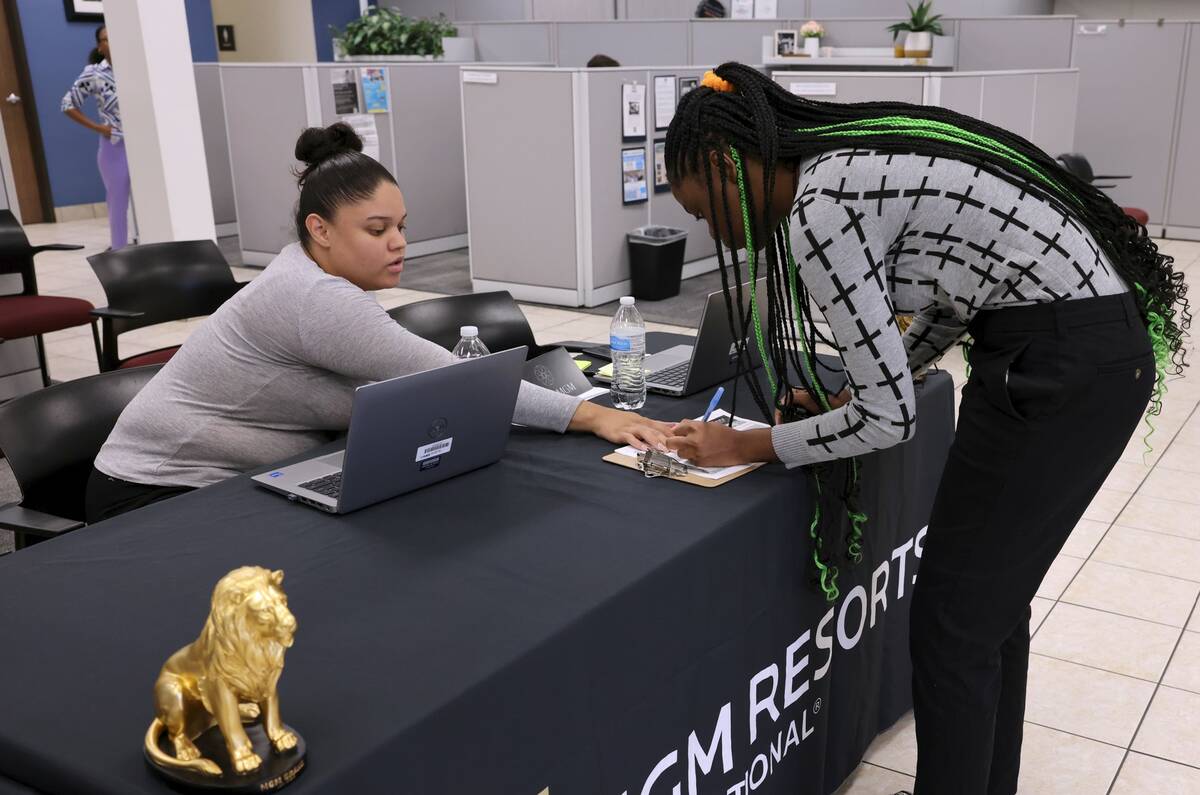 Job seeker Tieyana, 18, right, checks in with Shalynn Kelly during an MGM Resorts International ...