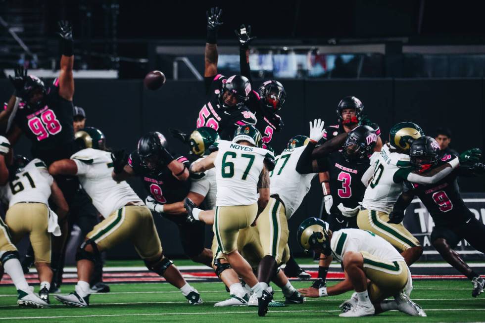 UNLV defenders try to block a field goal by Colorado State place kicker Jordan Noyes (67) durin ...