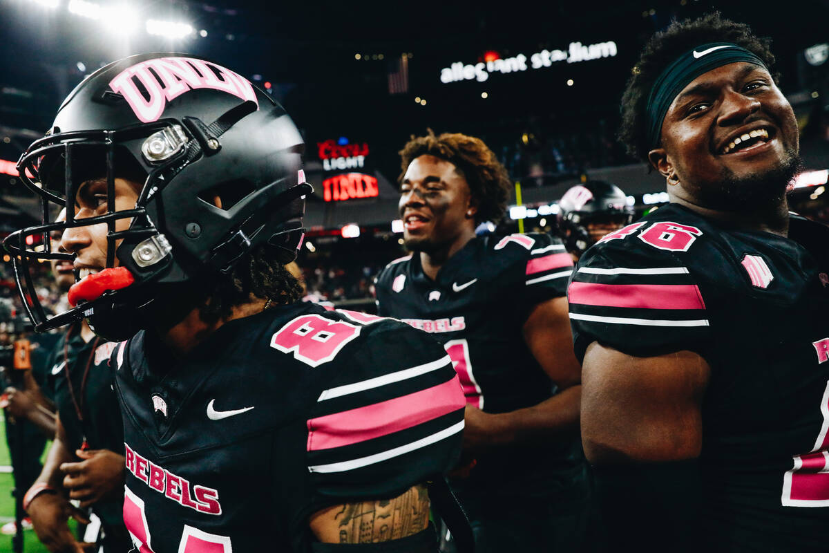 UNLV players celebrate after beating Colorado State and becoming bowl eligible at Allegiant Sta ...
