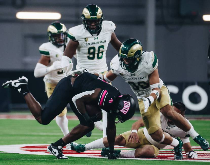 UNLV running back Donavyn Lester (4) falls with the ball during a game against Colorado State a ...