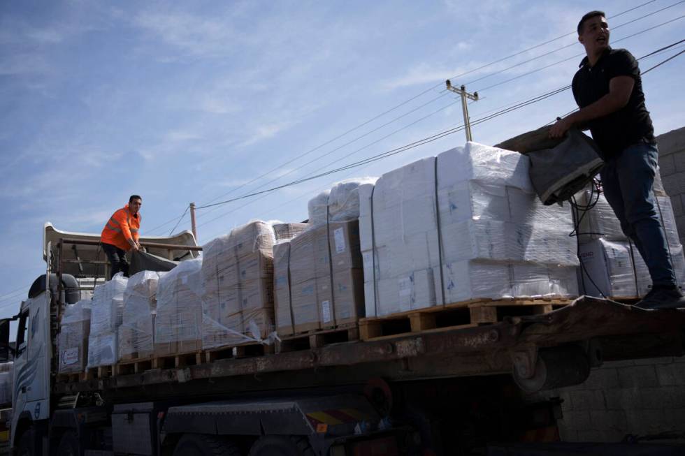 Trucks with humanitarian aid for the 'Gaza Strip enter from Egypt in Rafah on Saturday, Oct. 21 ...