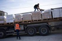 Trucks with humanitarian aid for the 'Gaza Strip enter from Egypt in Rafah on Saturday, Oct. 21 ...