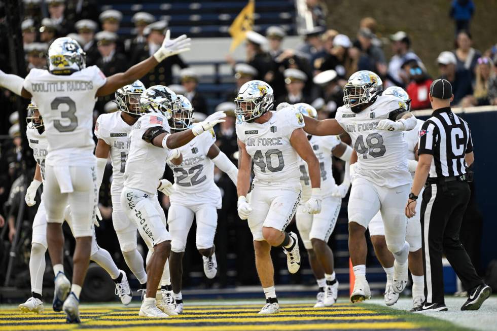 Air Force linebacker Alec Mock (40) celebrates with his teammates after scoring a touchdown on ...