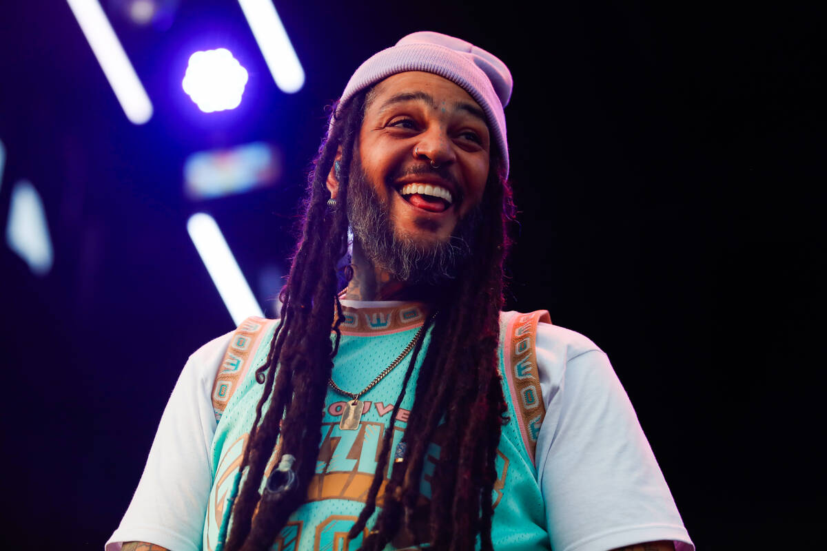 Gym Class Heroes’ lead singer, Travie McCoy, smiles at the crowd during a performance at ...