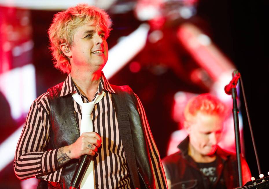 Green Day’s lead singer, Billie Joe Armstrong, smiles at the crowd during a performance ...