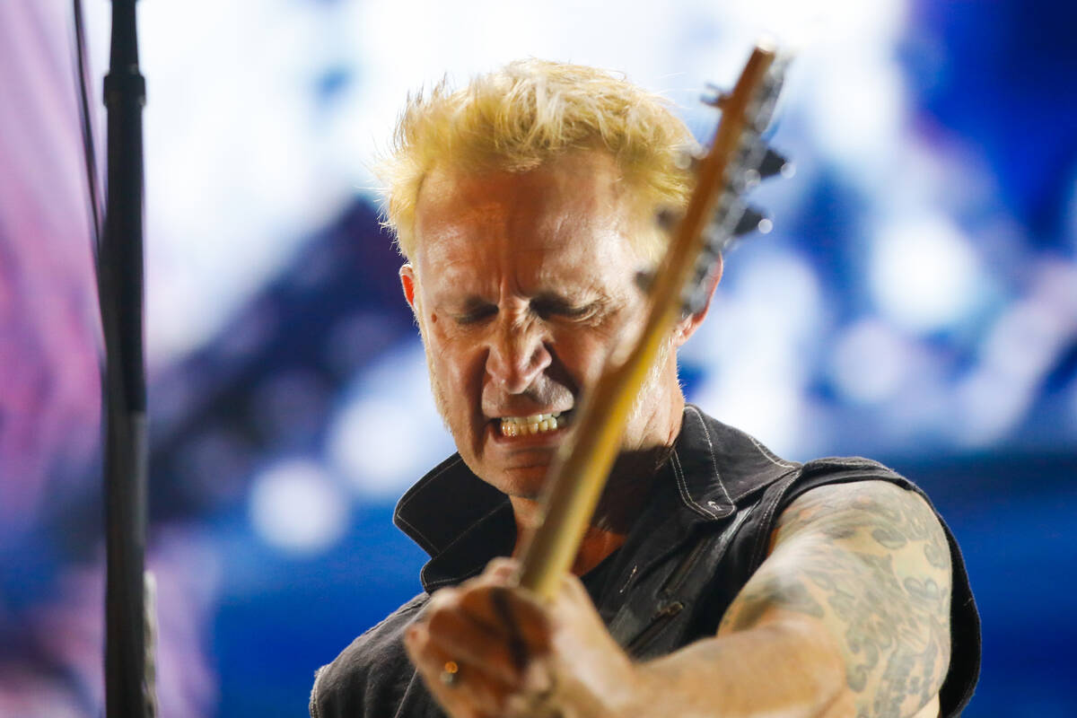 Green Day’s bassist and backing vocalist, Mike Dirnt, plays the bass during a performanc ...