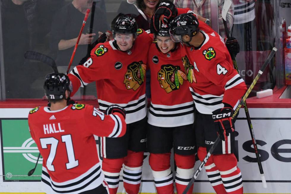 Chicago Blackhawks' Connor Bedard (98) celebrates with teammates Ryan Donato (8), Seth Jones (4 ...