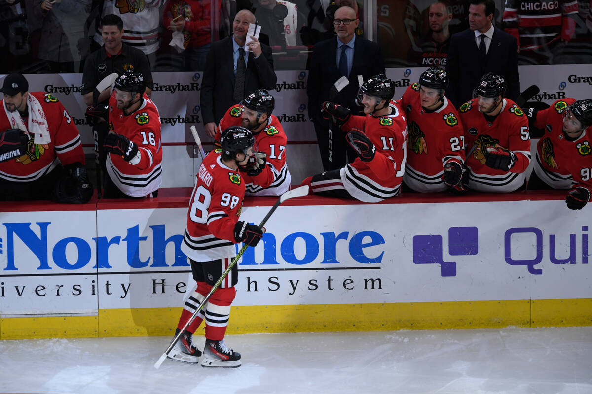 Chicago Blackhawks' Connor Bedard (98) celebrates with teammates at the bench after scoring a g ...